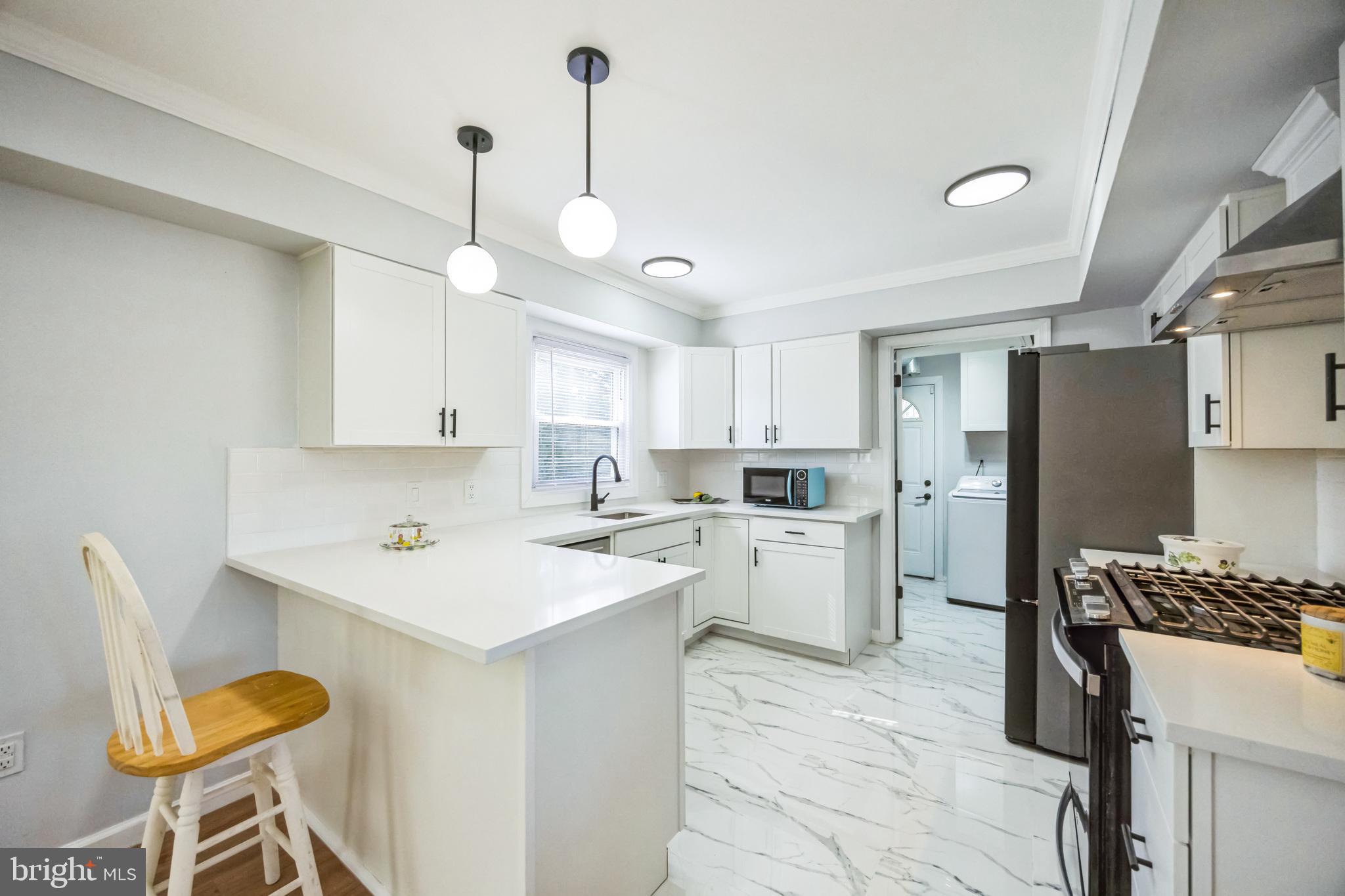 59 Manor Lane Willingboro, NJ 08046 - Photo 10 of 28 a kitchen with a sink a counter space appliances and cabinets