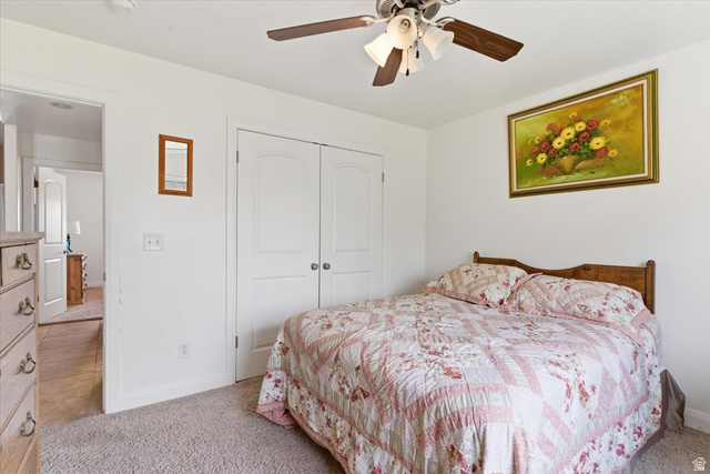 6237 West 4600th Street South Hooper, UT 84315 - Photo 18 of 48 Bedroom featuring light colored carpet, a closet, and ceiling fan