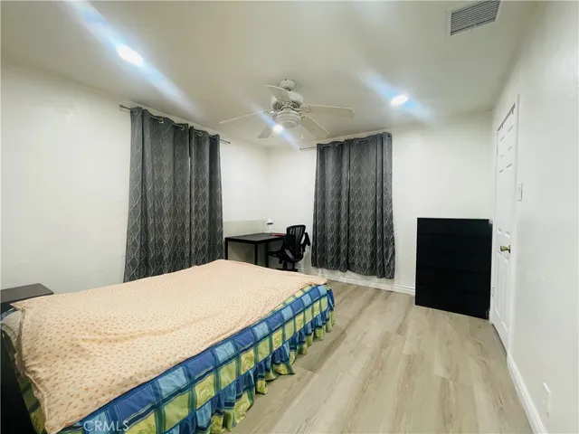 a bedroom with a bed and a dresser