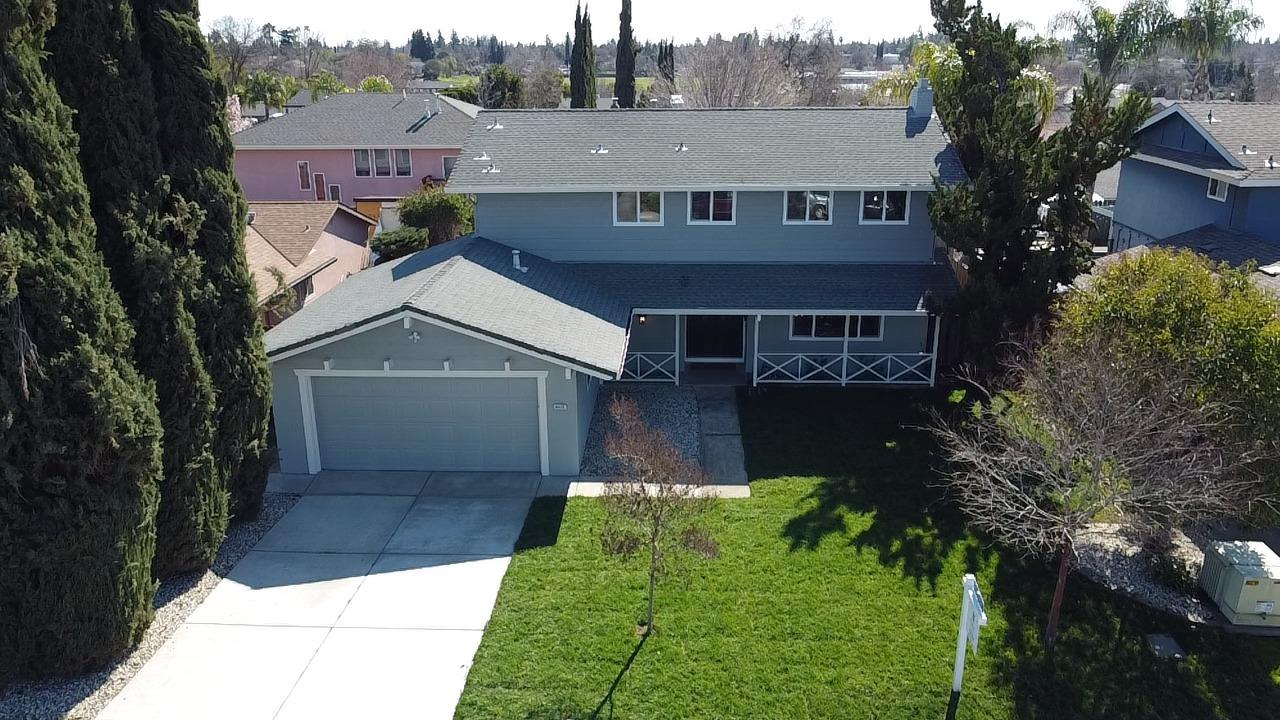 a aerial view of a house next to a yard