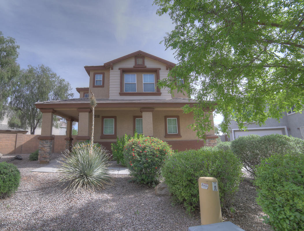 3902 West Carter Road Phoenix, AZ 85041 - Photo 1 of 38 a front view of a house with a yard and trees