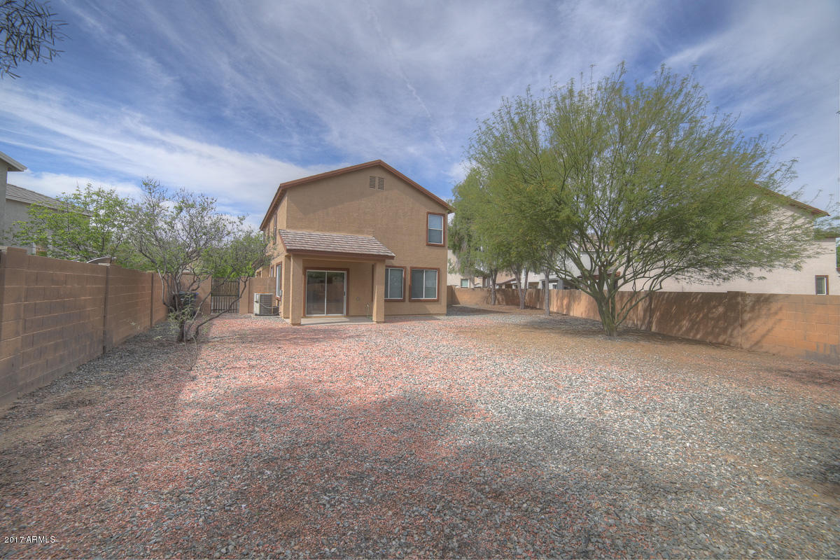 3902 West Carter Road Phoenix, AZ 85041 - Photo 2 of 38 a view of a house with a yard and a garage