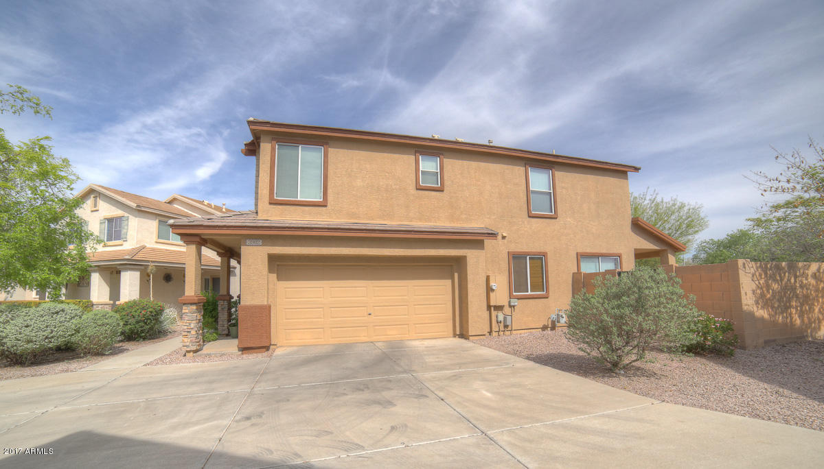 3902 West Carter Road Phoenix, AZ 85041 - Photo 34 of 38 a front view of a house with a yard and garage