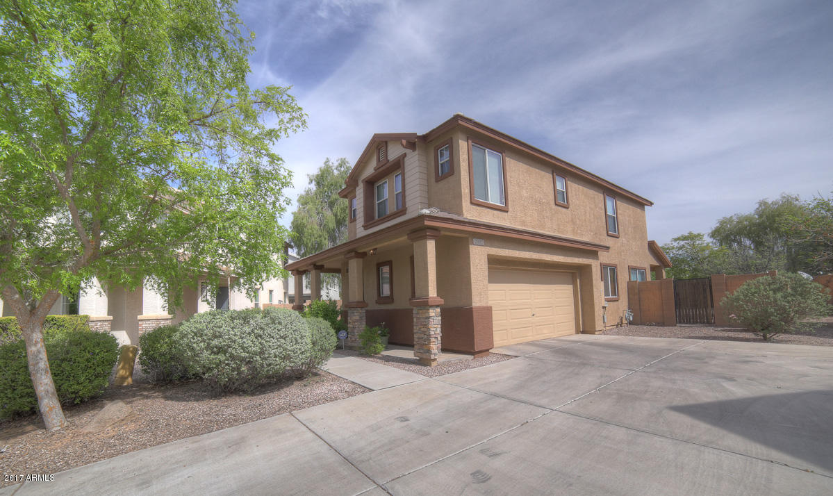 3902 West Carter Road Phoenix, AZ 85041 - Photo 4 of 38 a front view of a house with a yard and garage