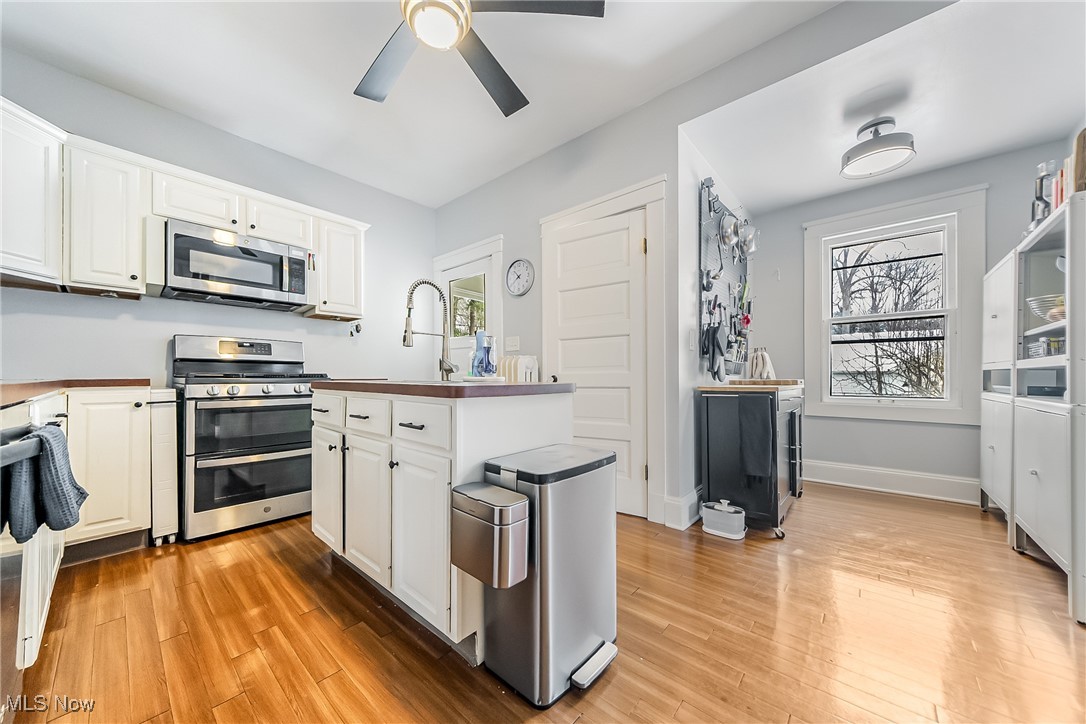 3733 Montevista Road Cleveland, OH 44121 - Photo 11 of 35 Kitchen featuring white cabinets, stainless steel appliances, and ceiling fan