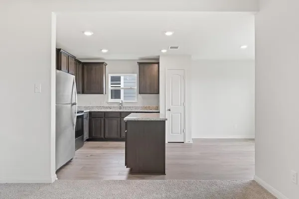 a kitchen with a refrigerator and a sink