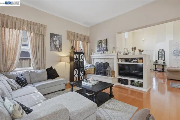 a living room with furniture a flat screen tv and a fireplace