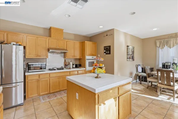 a kitchen with a sink a stove cabinets and counter space