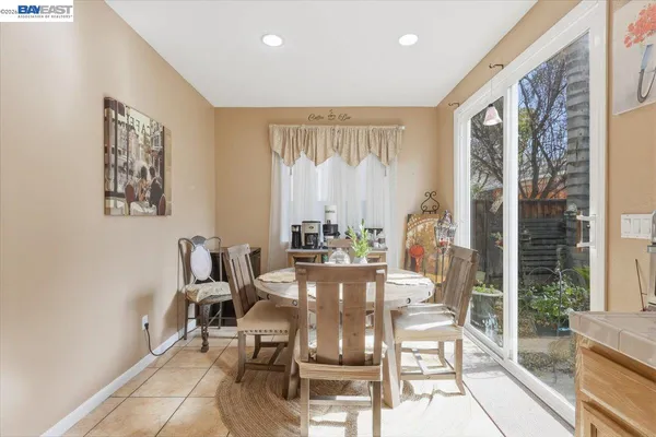 a bathroom with a tub a sink double vanity and windows