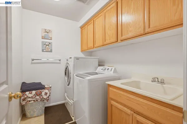 a bedroom with a white bed and a sink