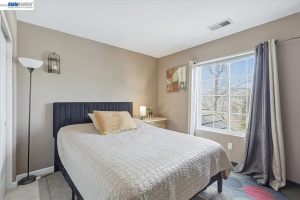 a bedroom with a bed and a table