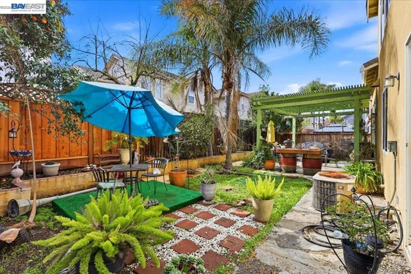 a view of a patio with chairs and table under an umbrella