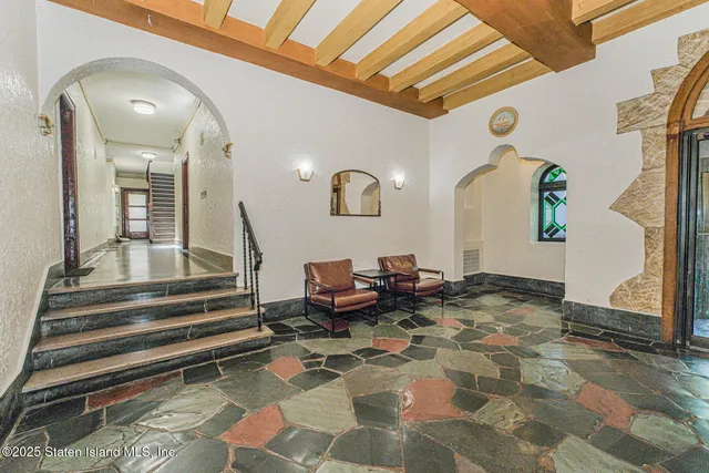 a view of a hallway with dining area and chandelier