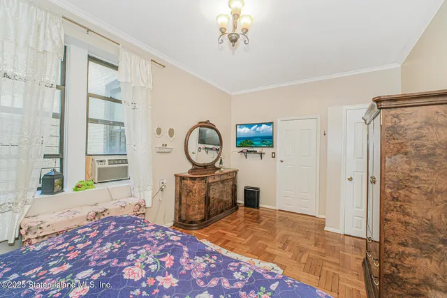 a bedroom with a bed and a chandelier