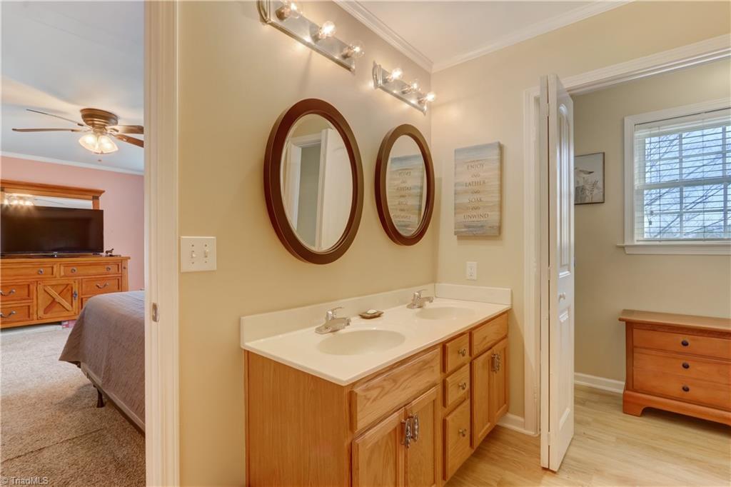 6010 Sandy Creek Church Road Staley, NC 27355 - Photo 16 of 38 Owner's bath with double sinks and lovely yard view