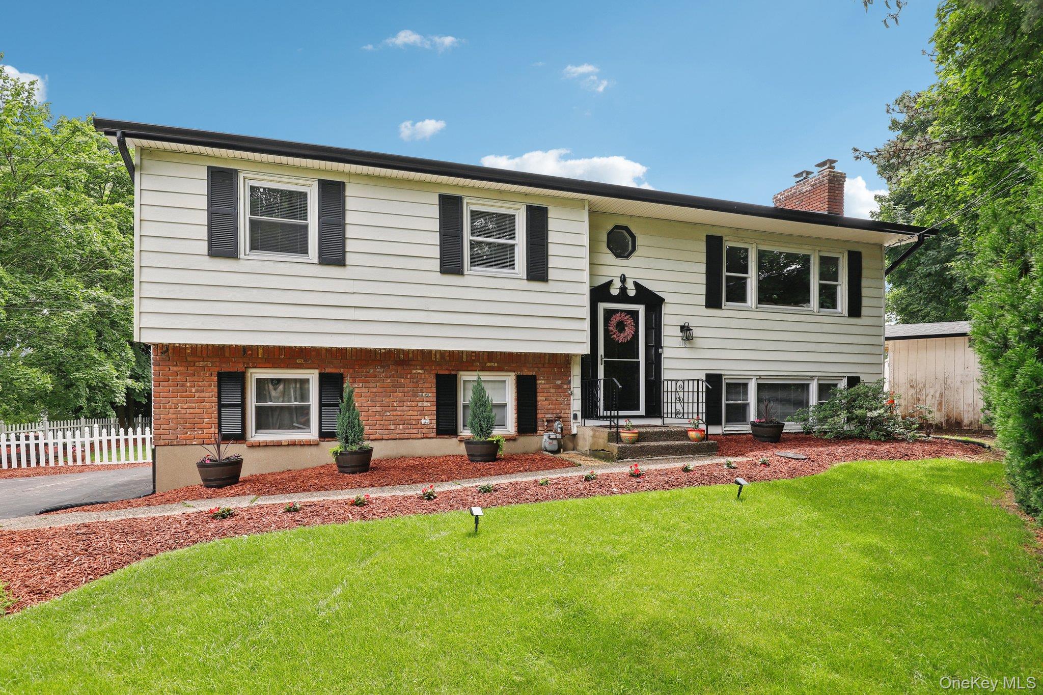 a front view of house with yard and outdoor seating