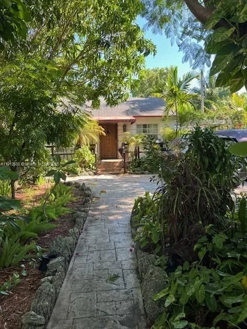 a backyard of a house with yard and outdoor seating