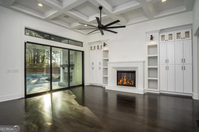 a view of a livingroom with a fireplace wooden floor and window