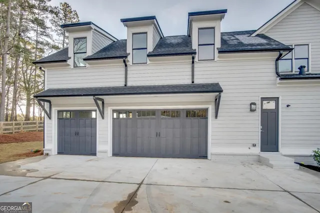 a front view of a house with garage
