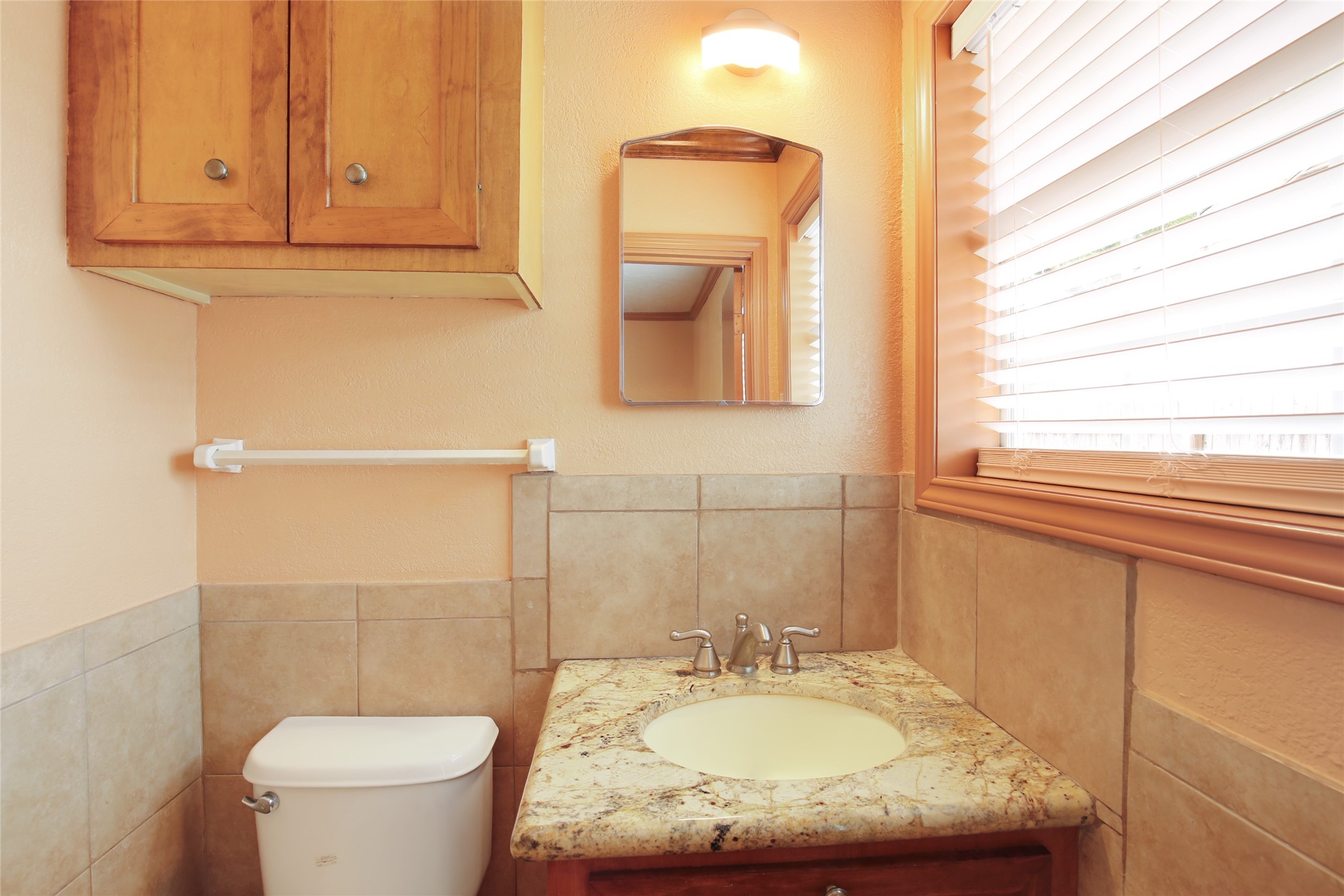 6923 Leader Street Houston, TX 77074 - Photo 9 of 19 a bathroom with a granite countertop sink toilet and mirror