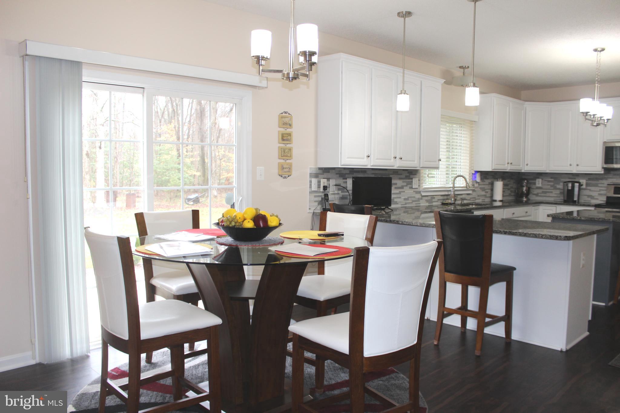 3470 Malcolm Road Brandywine, MD 20613 - Photo 15 of 55 a view of a dining room with furniture window and wooden floor