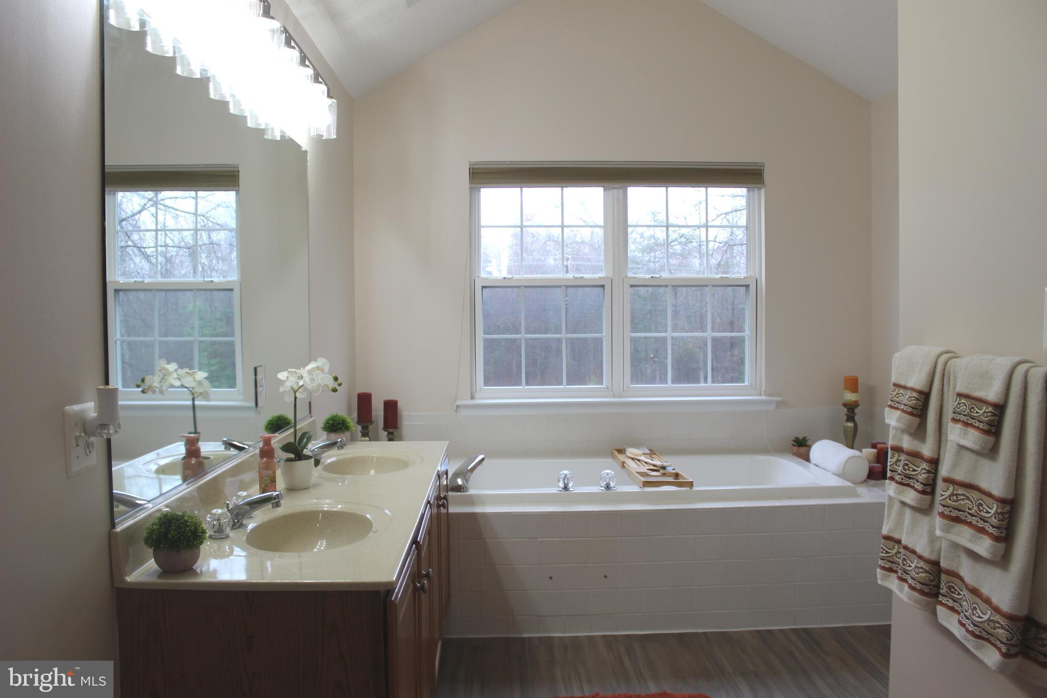 3470 Malcolm Road Brandywine, MD 20613 - Photo 30 of 55 a bathroom with a tub sink and mirror