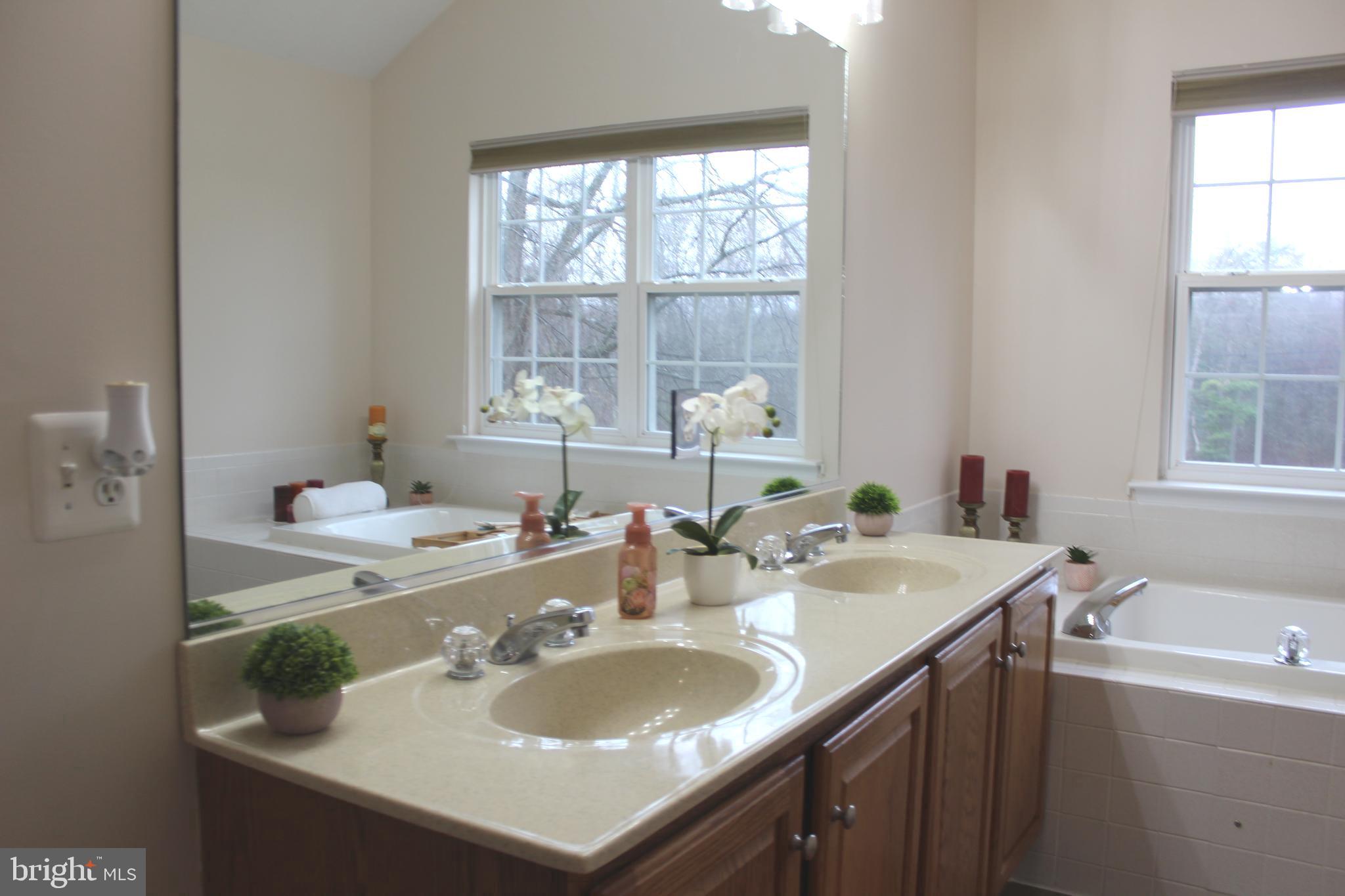 3470 Malcolm Road Brandywine, MD 20613 - Photo 32 of 55 a bathroom with a sink double vanity and a tub