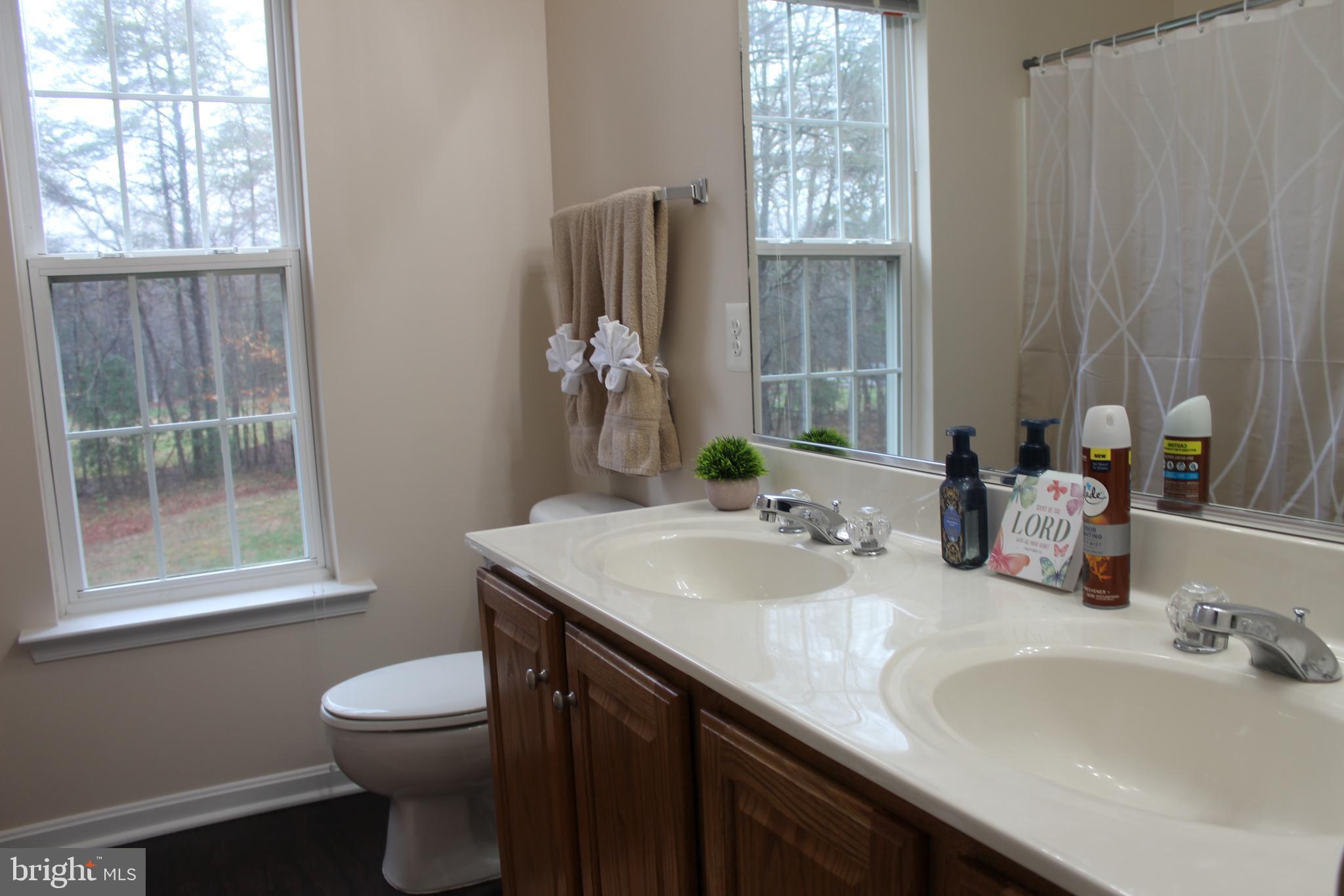 3470 Malcolm Road Brandywine, MD 20613 - Photo 36 of 55 a bathroom with a granite countertop sink toilet and mirror