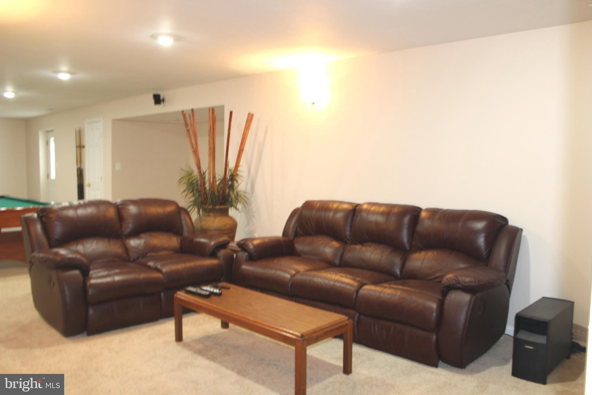 3470 Malcolm Road Brandywine, MD 20613 - Photo 41 of 55 a living room with furniture a couch and a flat screen tv