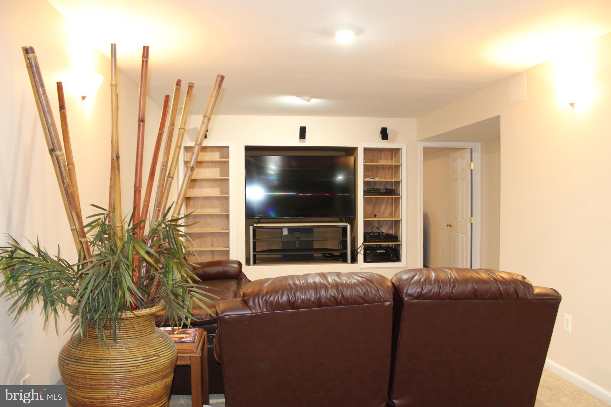 3470 Malcolm Road Brandywine, MD 20613 - Photo 42 of 55 a living room with furniture and a flat screen tv