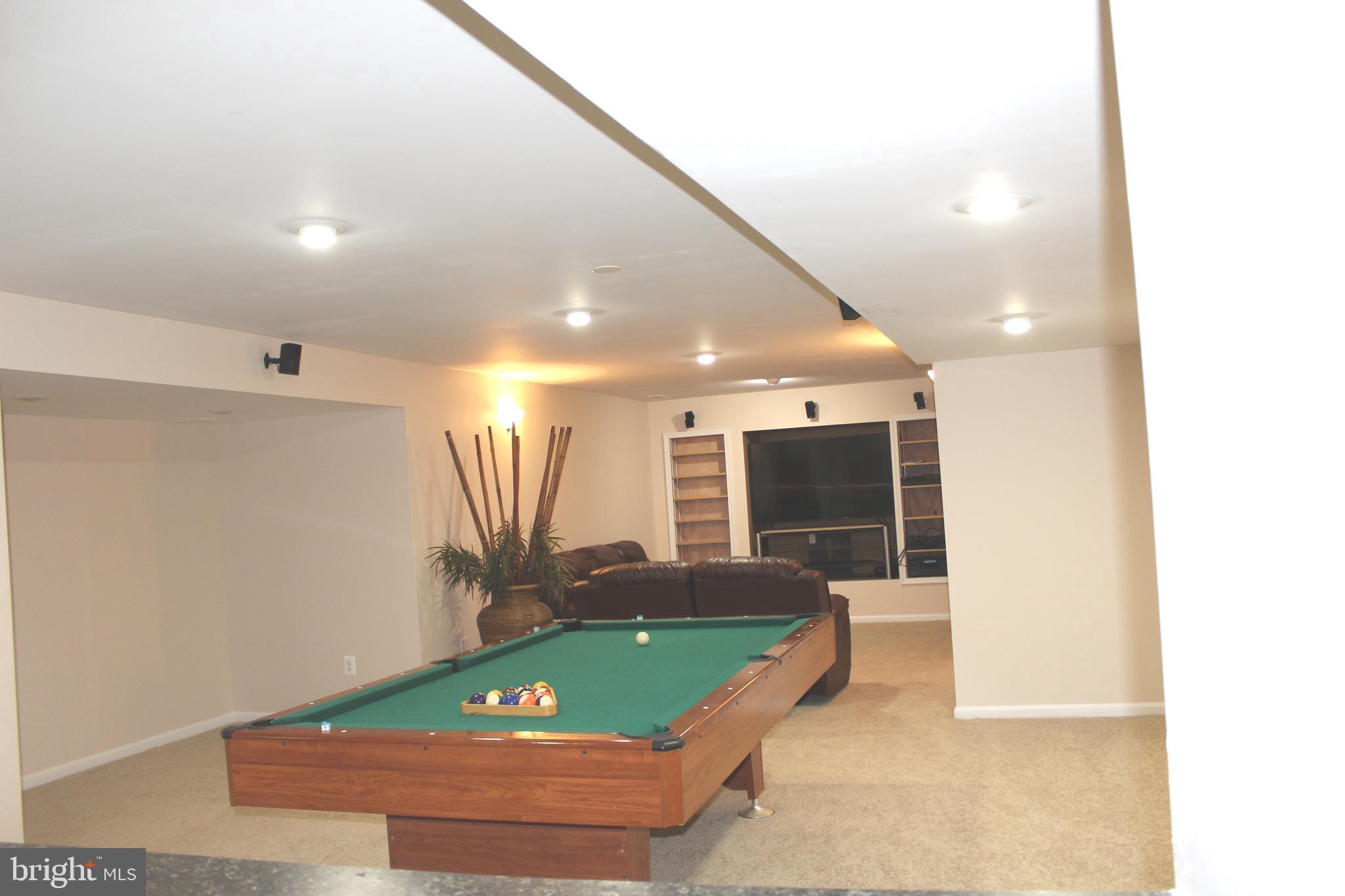 3470 Malcolm Road Brandywine, MD 20613 - Photo 43 of 55 a room with pool table a glass door and a rug