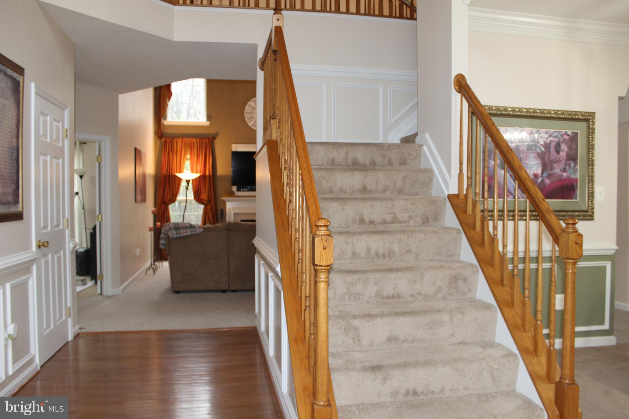 3470 Malcolm Road Brandywine, MD 20613 - Photo 54 of 55 a view of staircase with white walls and a painting on the wall