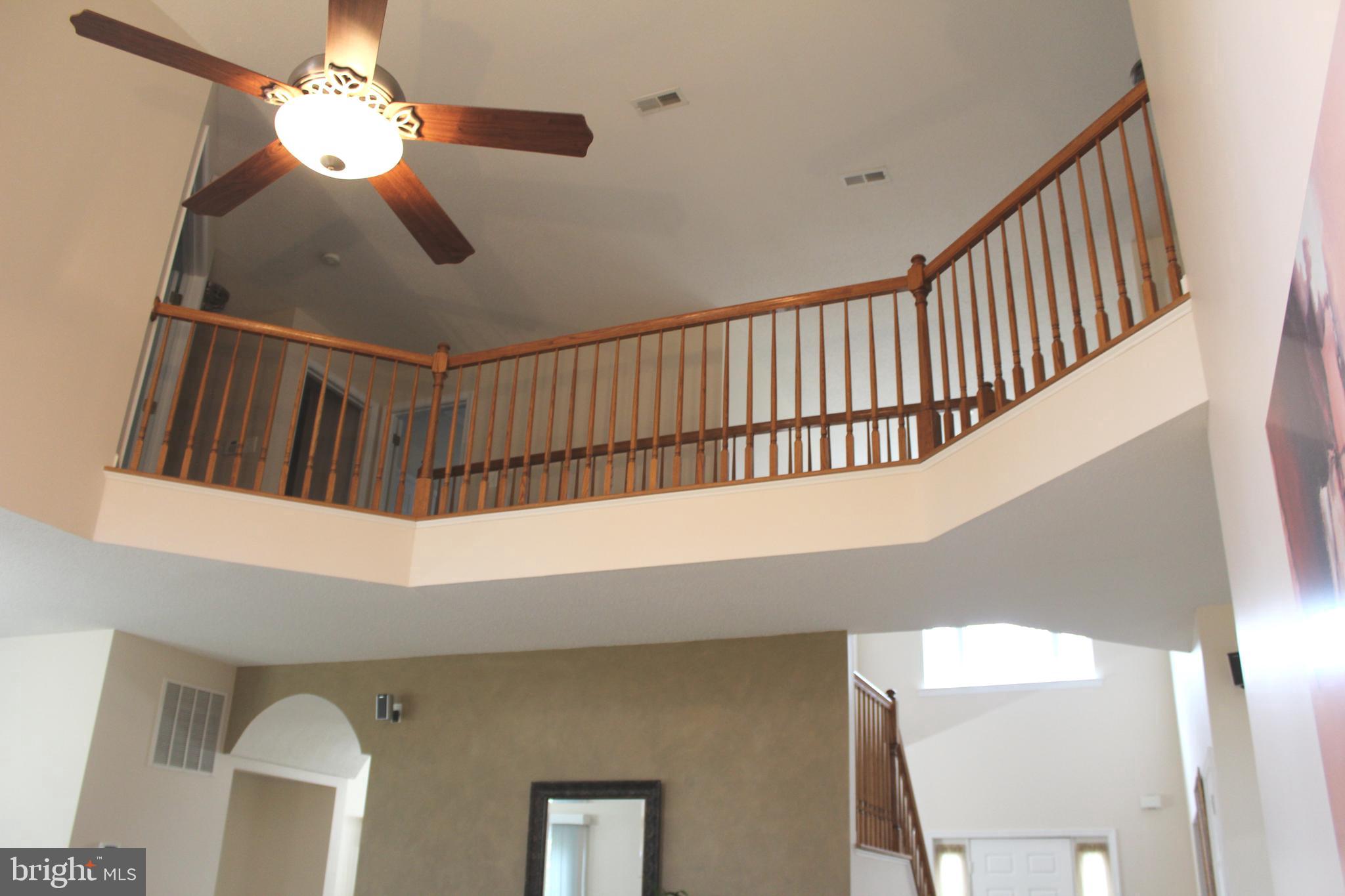 3470 Malcolm Road Brandywine, MD 20613 - Photo 7 of 55 a view of staircase with railing and a chandelier