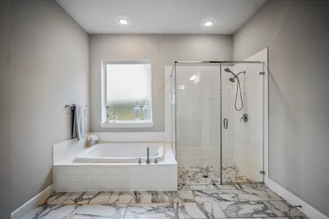 a bathroom with a bathtub and a shower