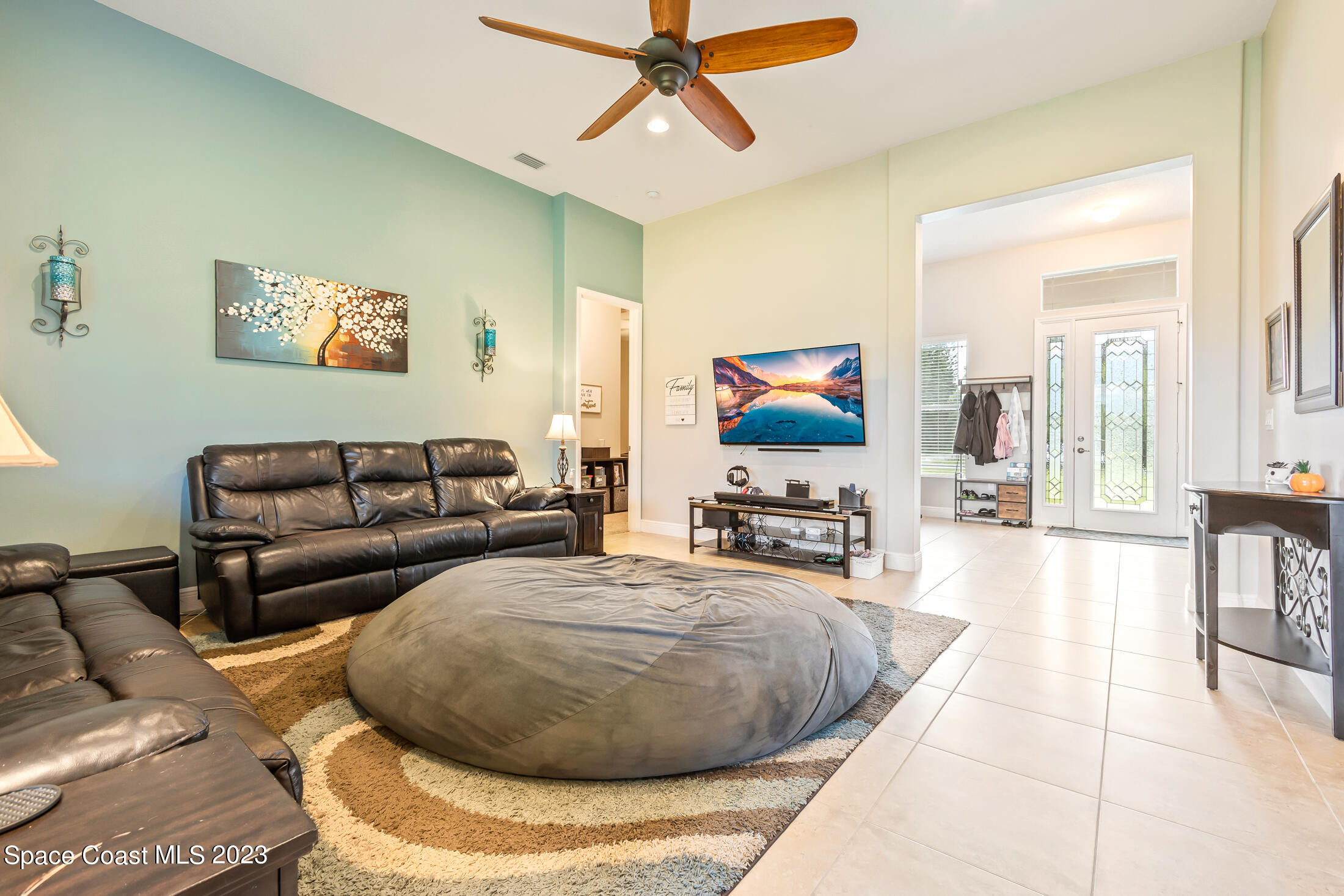 1840 Trimble Road Melbourne, FL 32934 - Photo 11 of 42 a living room with furniture and a flat screen tv