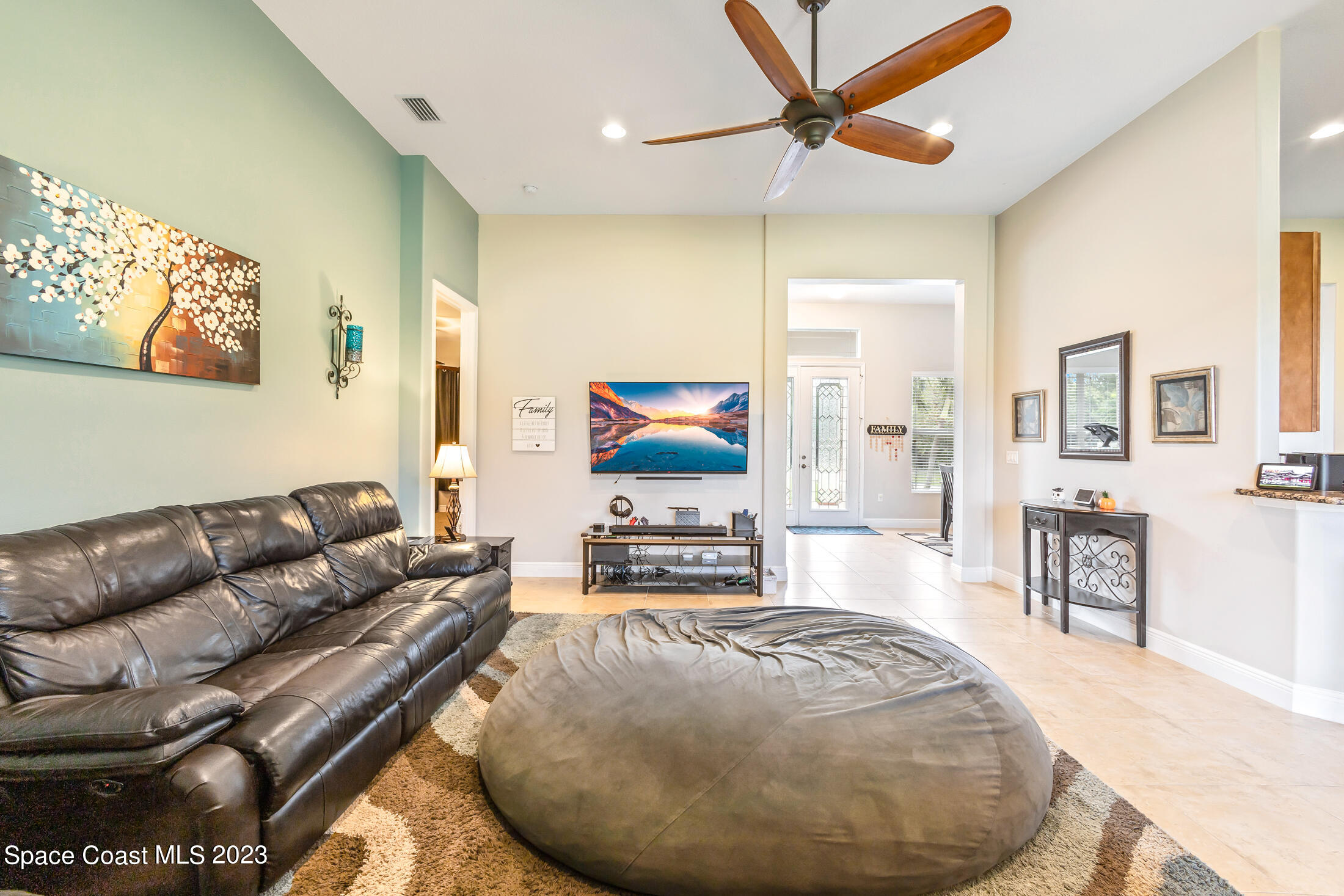 1840 Trimble Road Melbourne, FL 32934 - Photo 12 of 42 a living room with furniture and a flat screen tv
