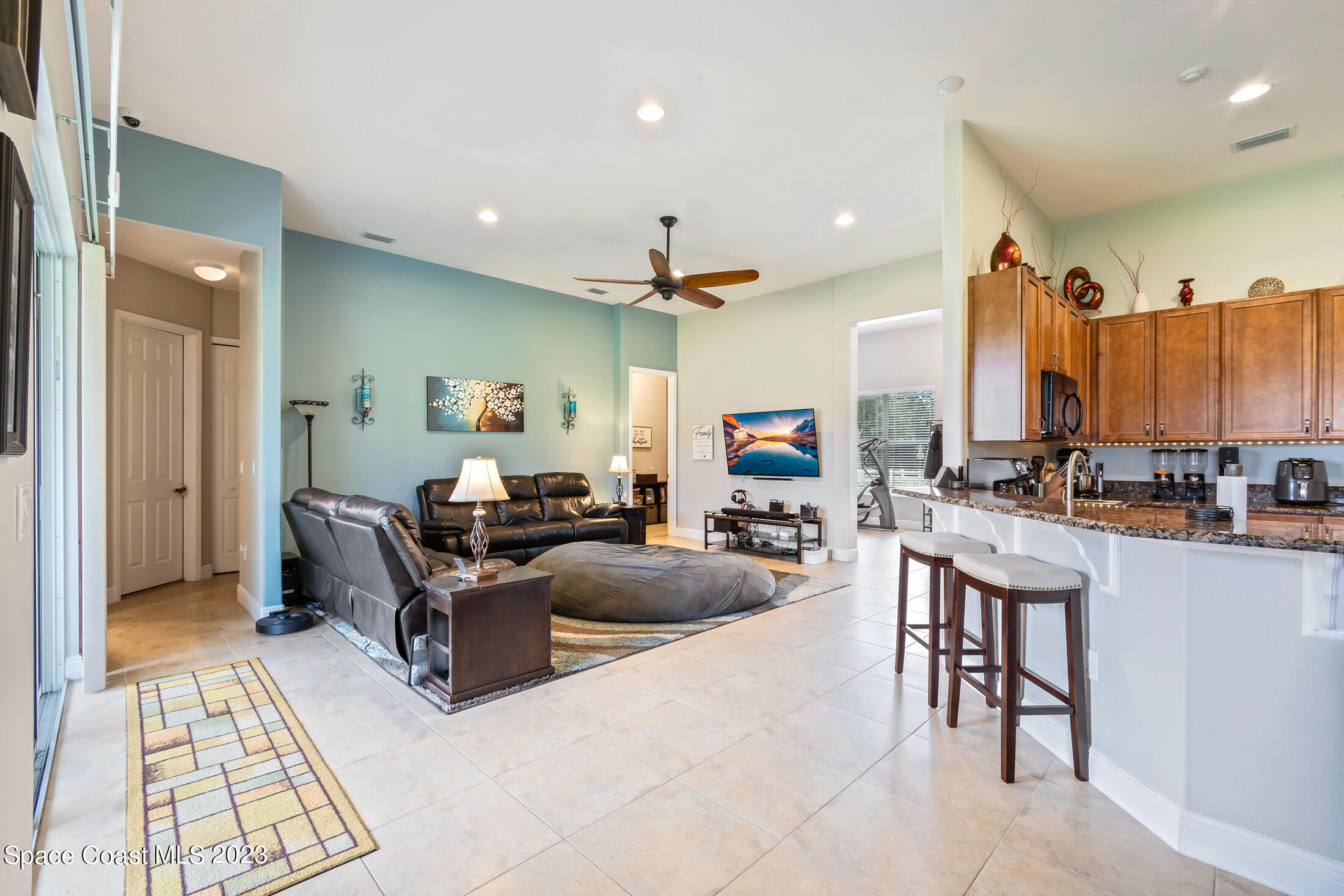 1840 Trimble Road Melbourne, FL 32934 - Photo 13 of 42 a living room with furniture a large window and a chandelier