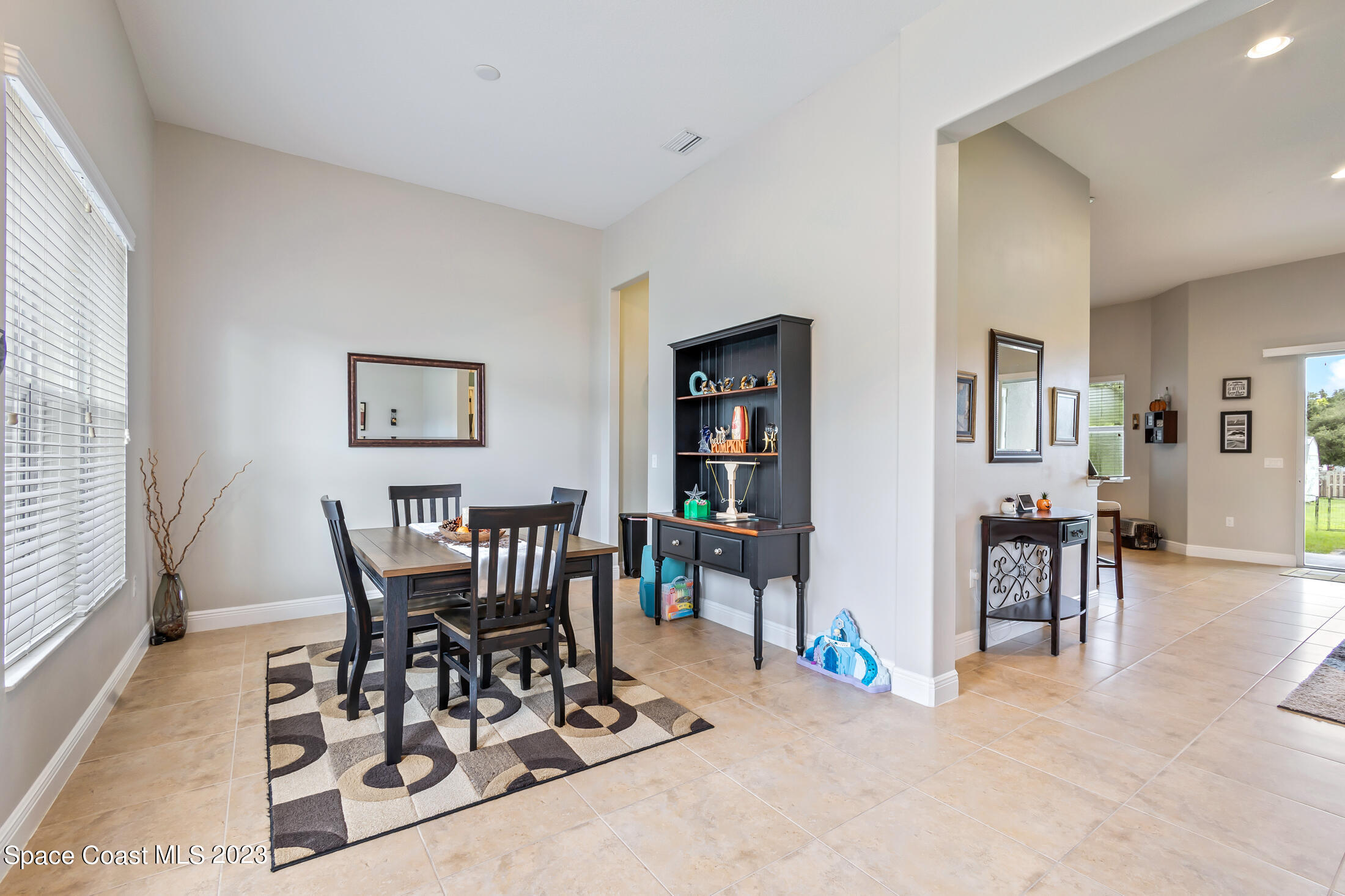 1840 Trimble Road Melbourne, FL 32934 - Photo 16 of 42 a view of a dining room with furniture and a potted plant