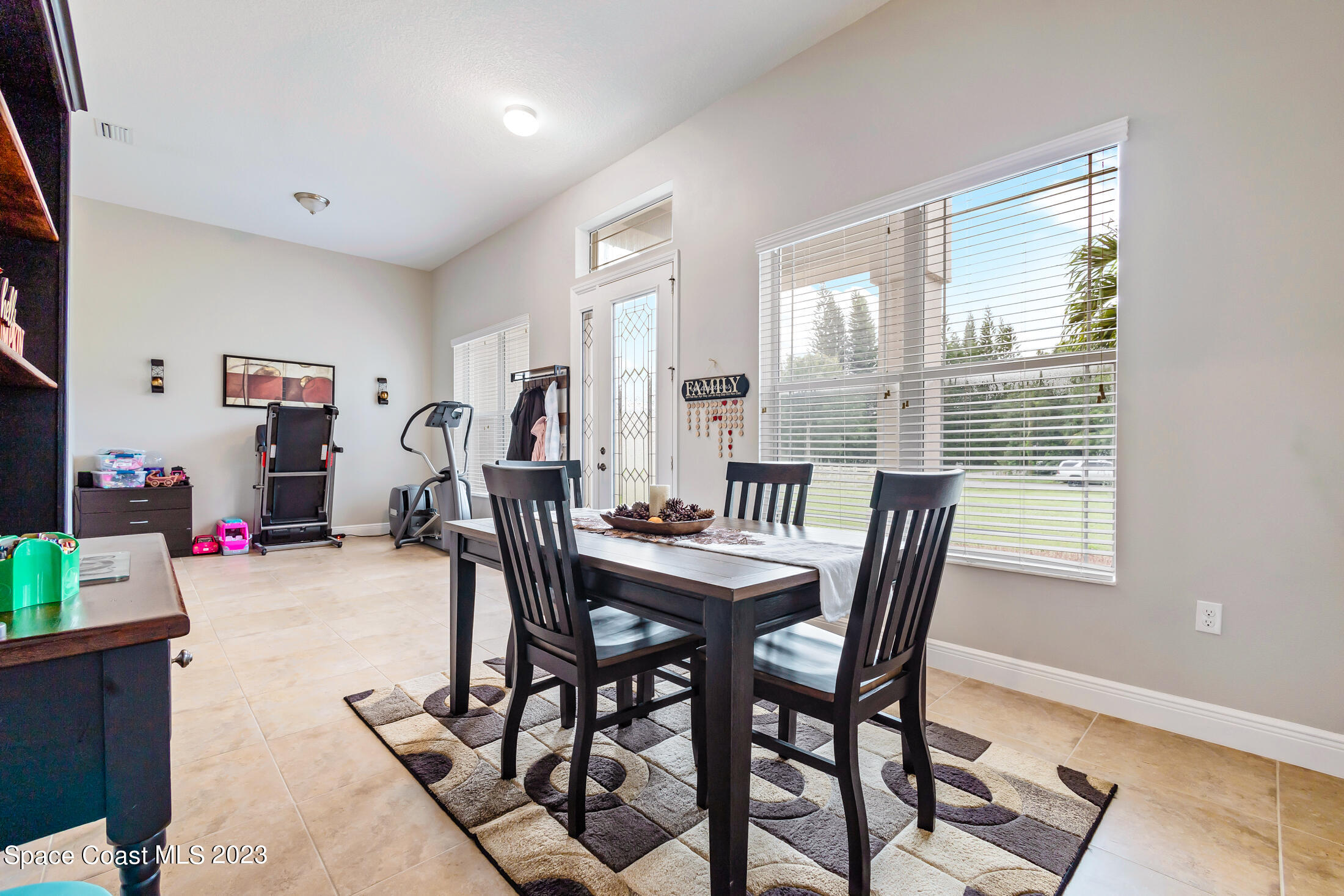 1840 Trimble Road Melbourne, FL 32934 - Photo 18 of 42 a view of a dining room with furniture and a window