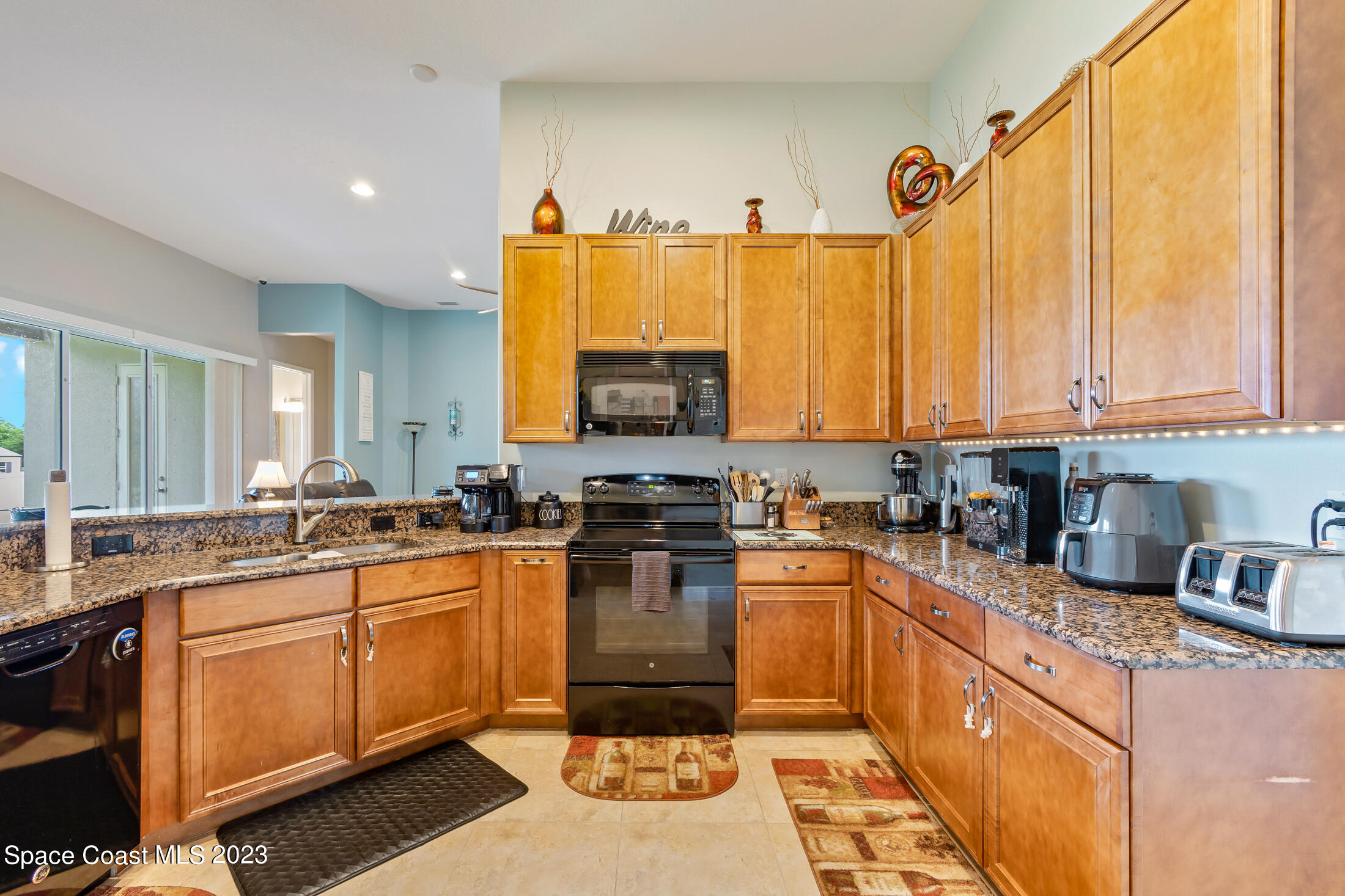 1840 Trimble Road Melbourne, FL 32934 - Photo 19 of 42 a kitchen with a sink stove and microwave