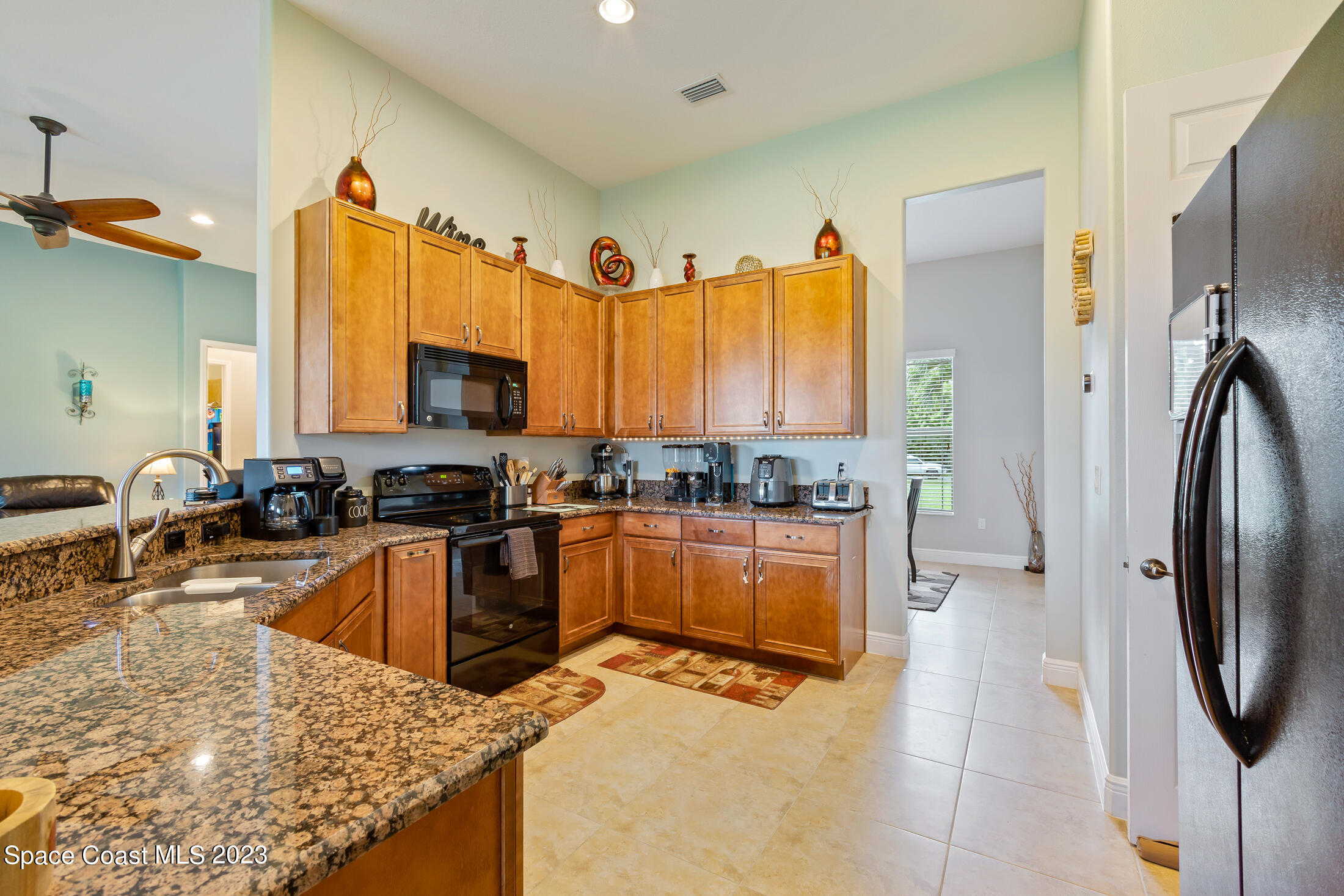 1840 Trimble Road Melbourne, FL 32934 - Photo 20 of 42 a kitchen with stainless steel appliances granite countertop a refrigerator a stove and a sink