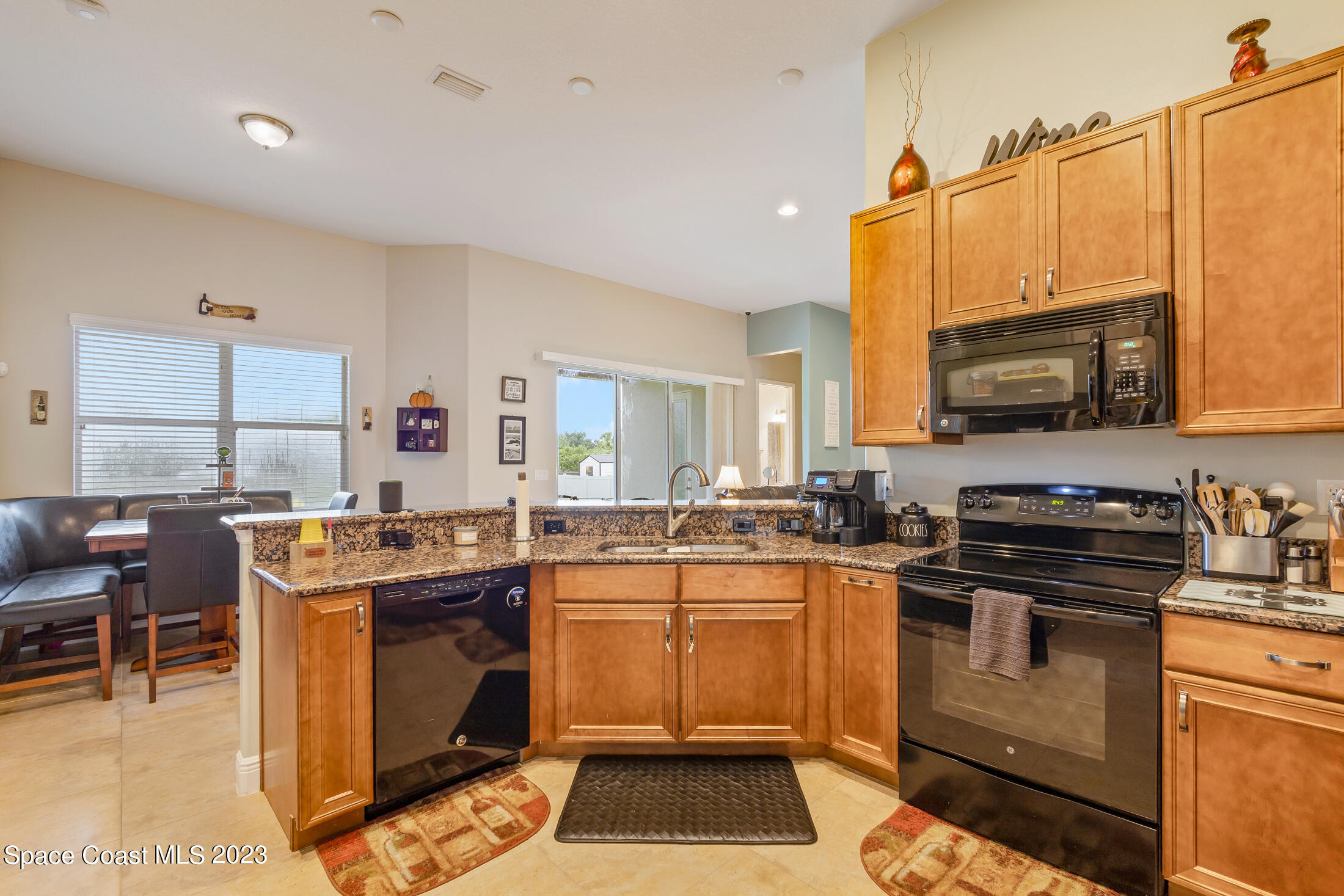 1840 Trimble Road Melbourne, FL 32934 - Photo 21 of 42 a kitchen that has a stove and a microwave