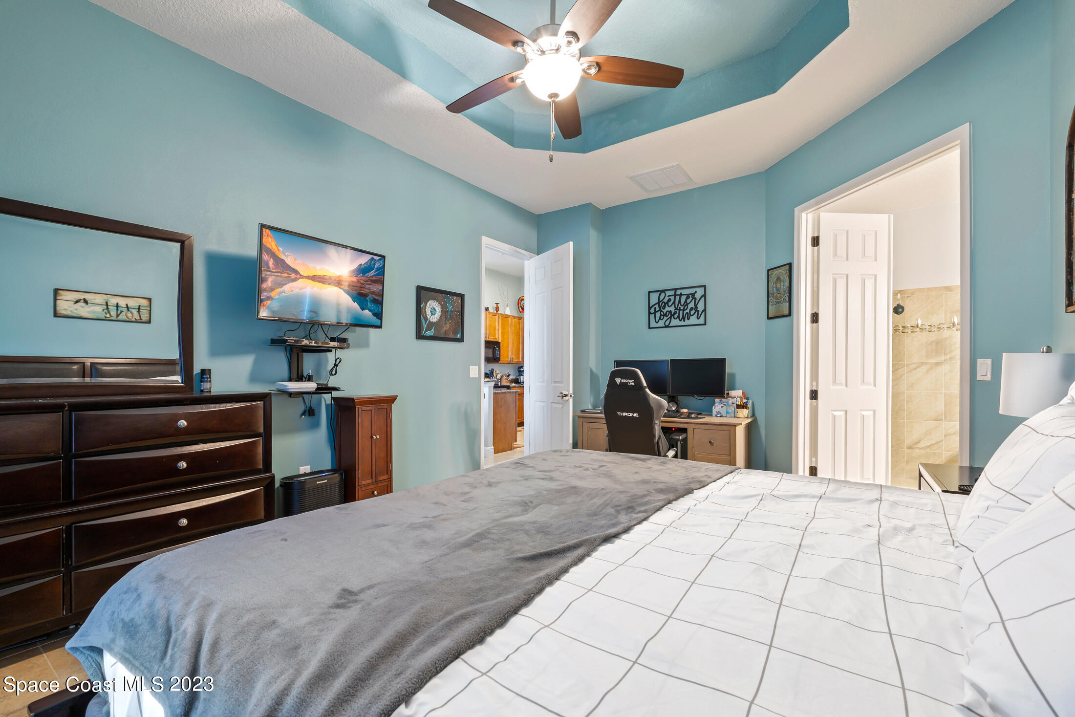 1840 Trimble Road Melbourne, FL 32934 - Photo 22 of 42 a bedroom with a bed and a flat screen tv