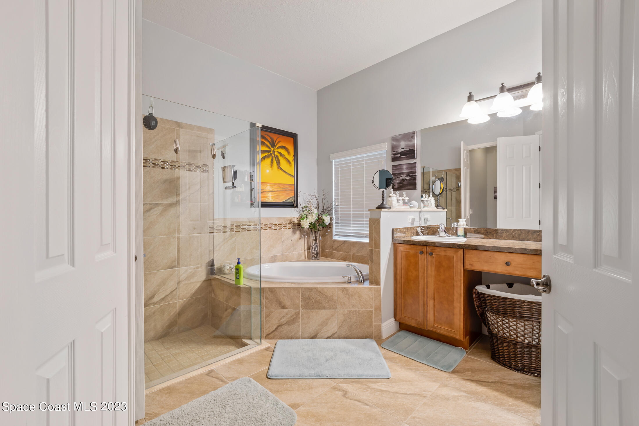 1840 Trimble Road Melbourne, FL 32934 - Photo 24 of 42 a spacious bathroom with a tub sink and mirror