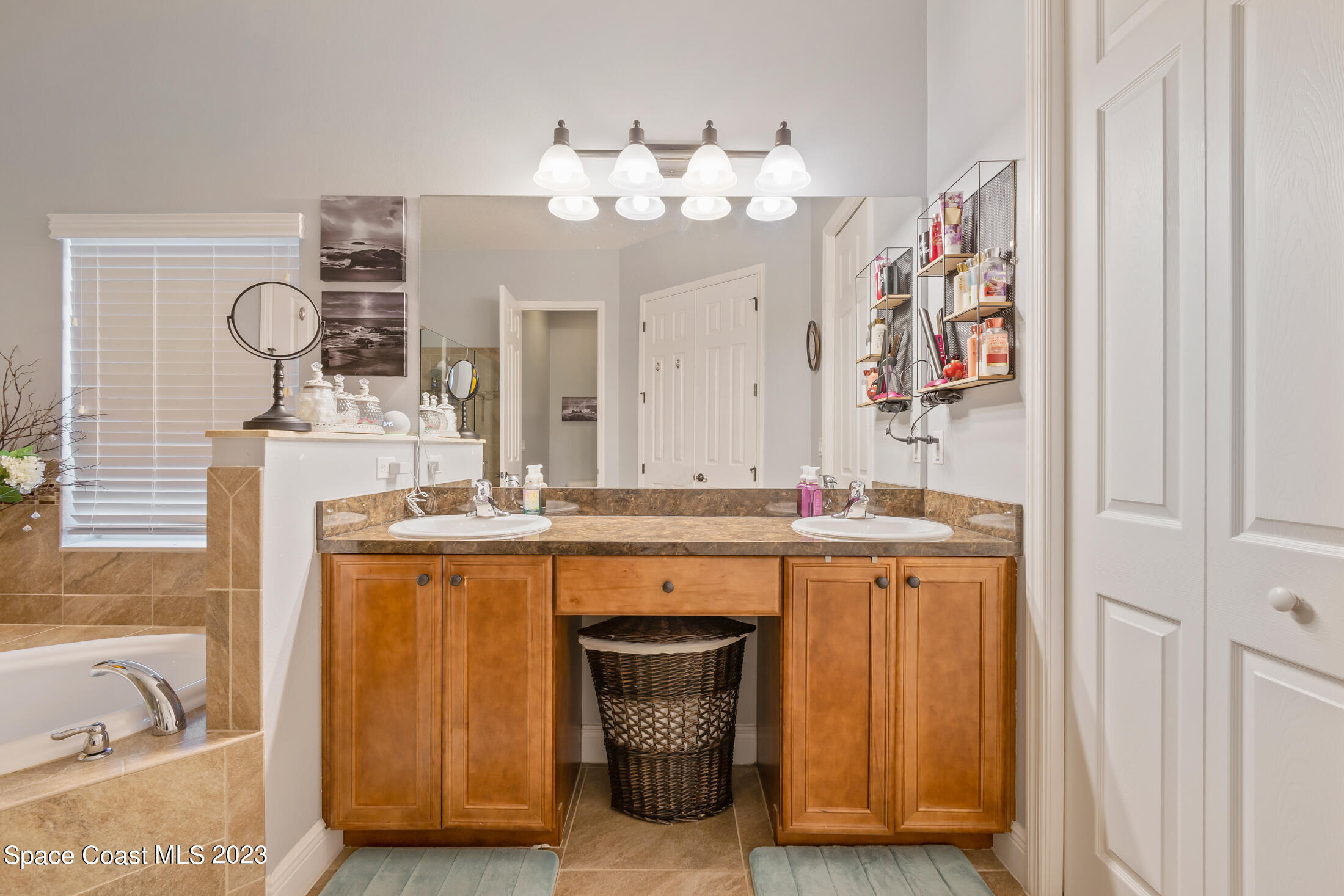 1840 Trimble Road Melbourne, FL 32934 - Photo 25 of 42 a bathroom with a sink and a mirror