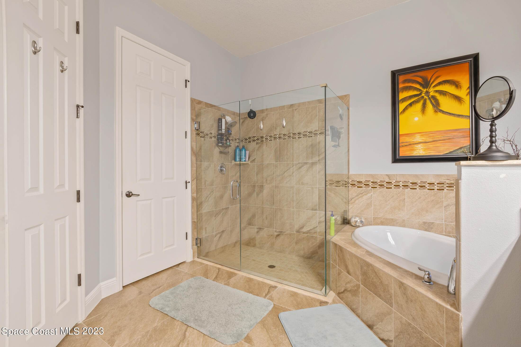 1840 Trimble Road Melbourne, FL 32934 - Photo 26 of 42 a bathroom with a sink a mirror a bathtub and shower