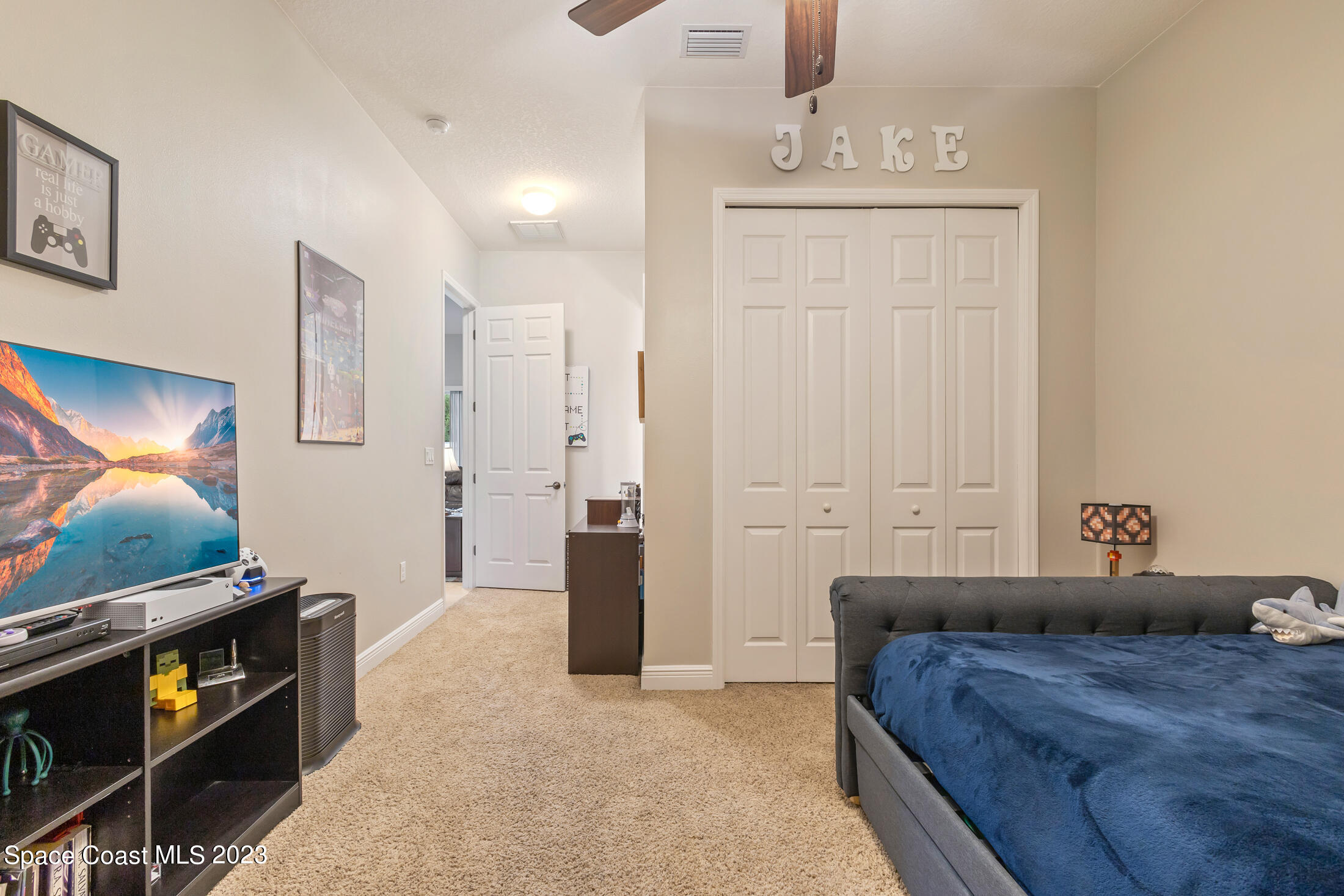 1840 Trimble Road Melbourne, FL 32934 - Photo 29 of 42 a bedroom with a bed and flat screen tv
