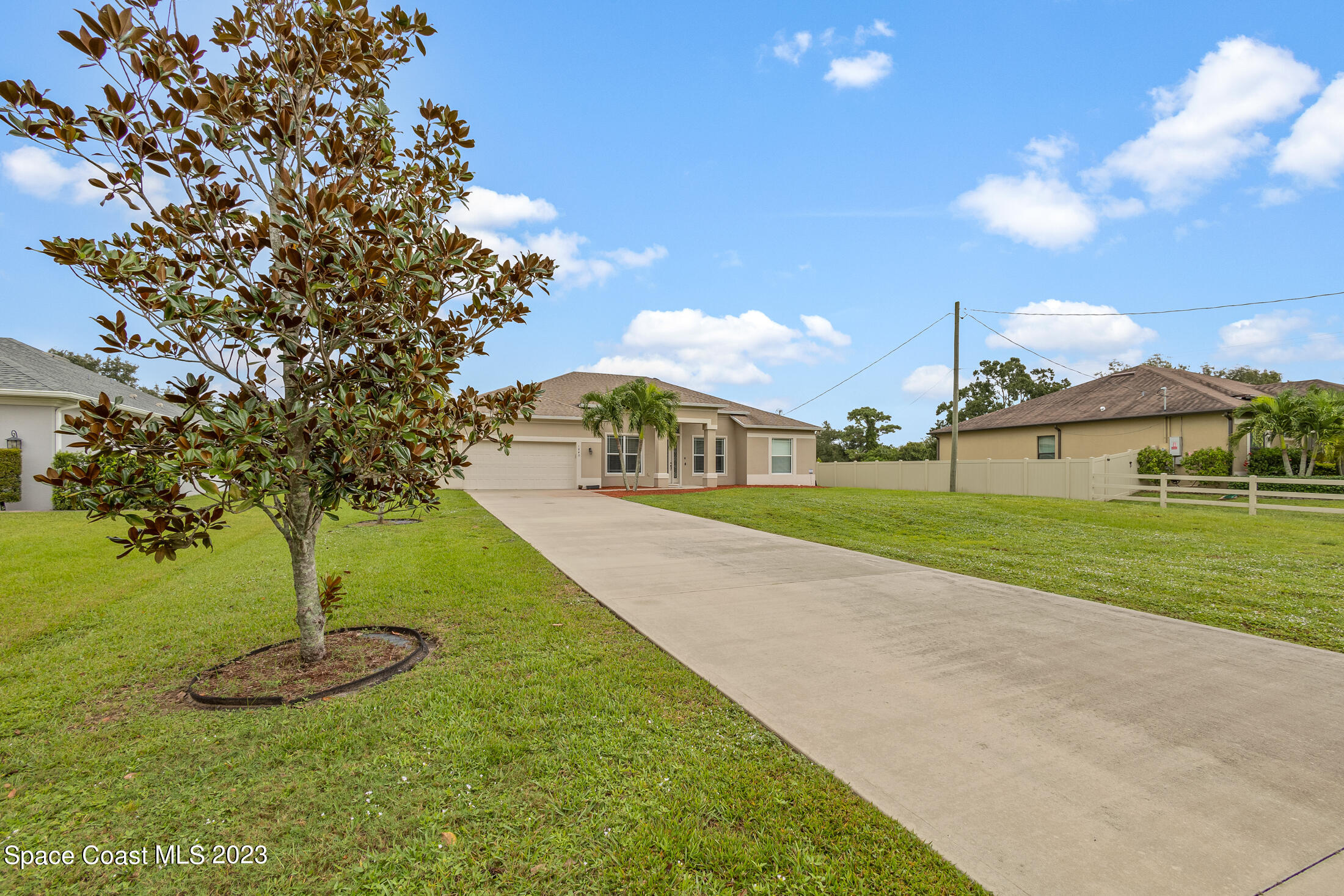 1840 Trimble Road Melbourne, FL 32934 - Photo 3 of 42 a view of a big yard with palm trees