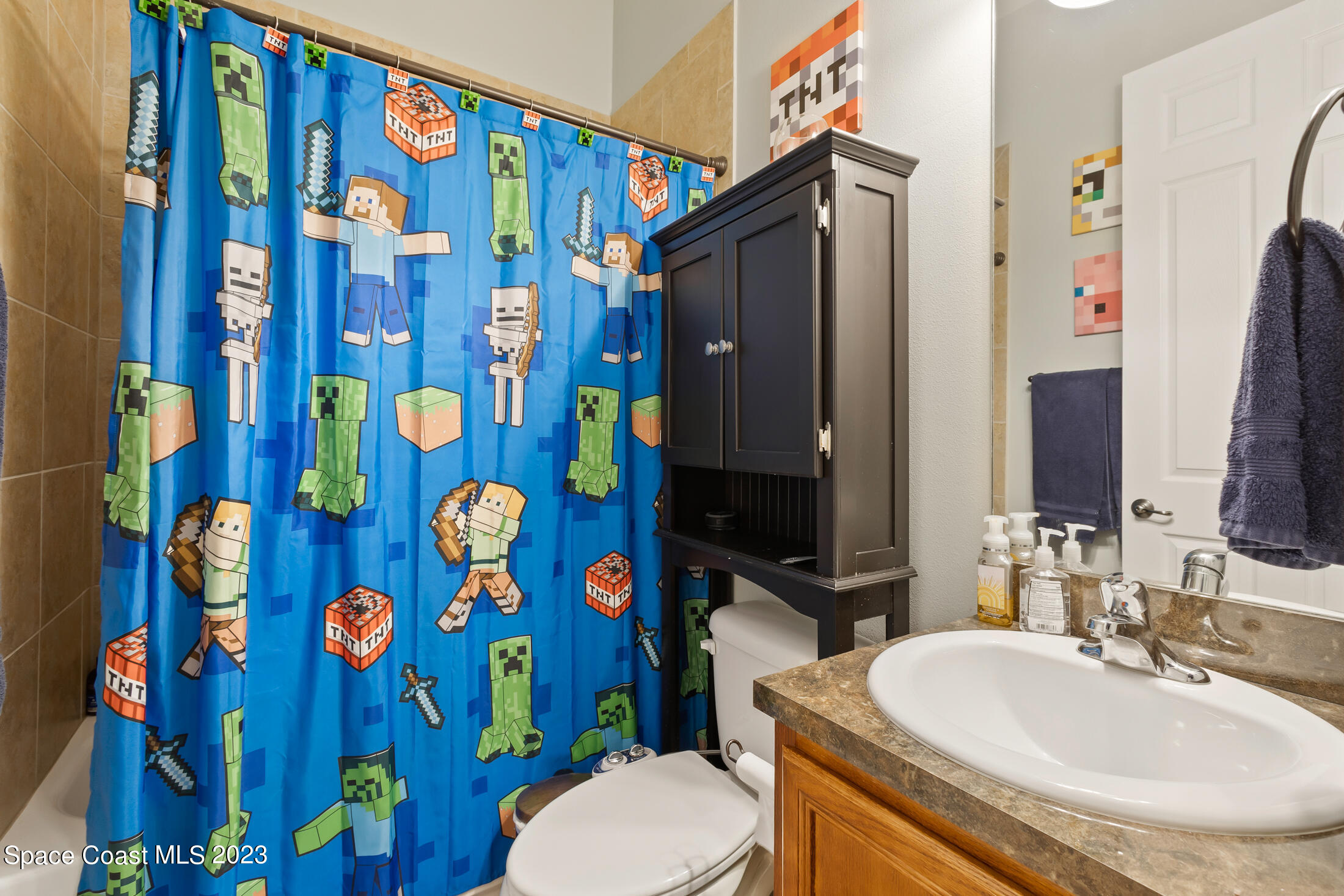 1840 Trimble Road Melbourne, FL 32934 - Photo 31 of 42 a bathroom with a sink and mirror with toilet