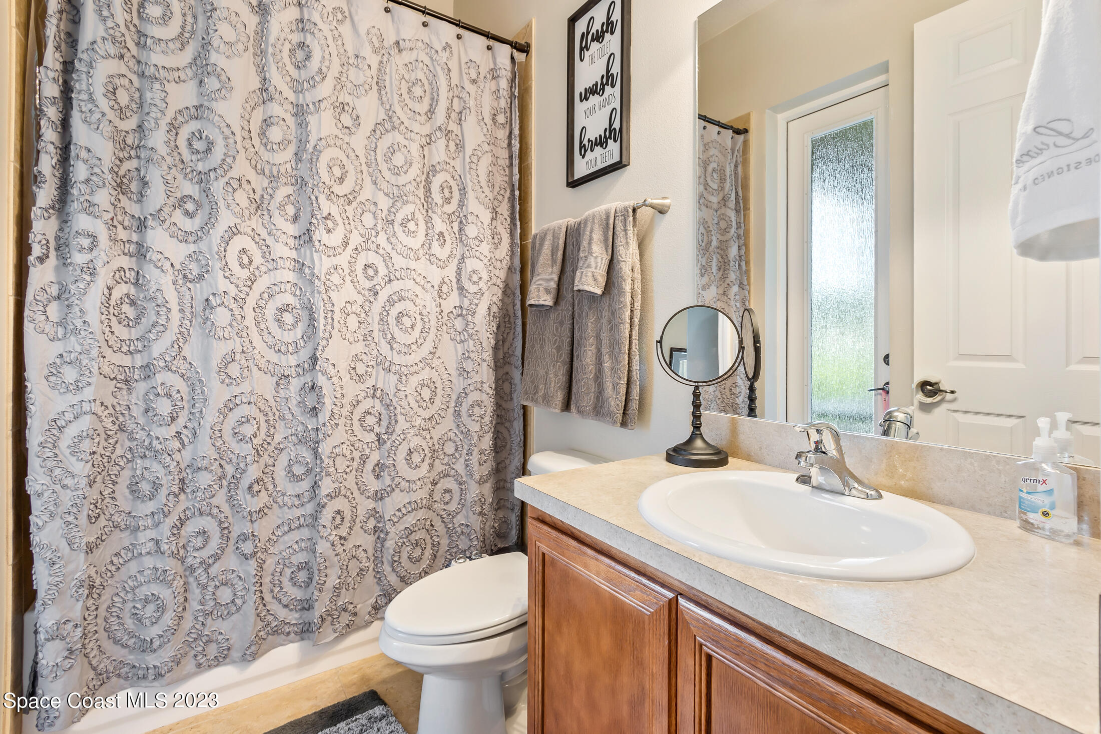 1840 Trimble Road Melbourne, FL 32934 - Photo 34 of 42 a bathroom with a sink and a mirror